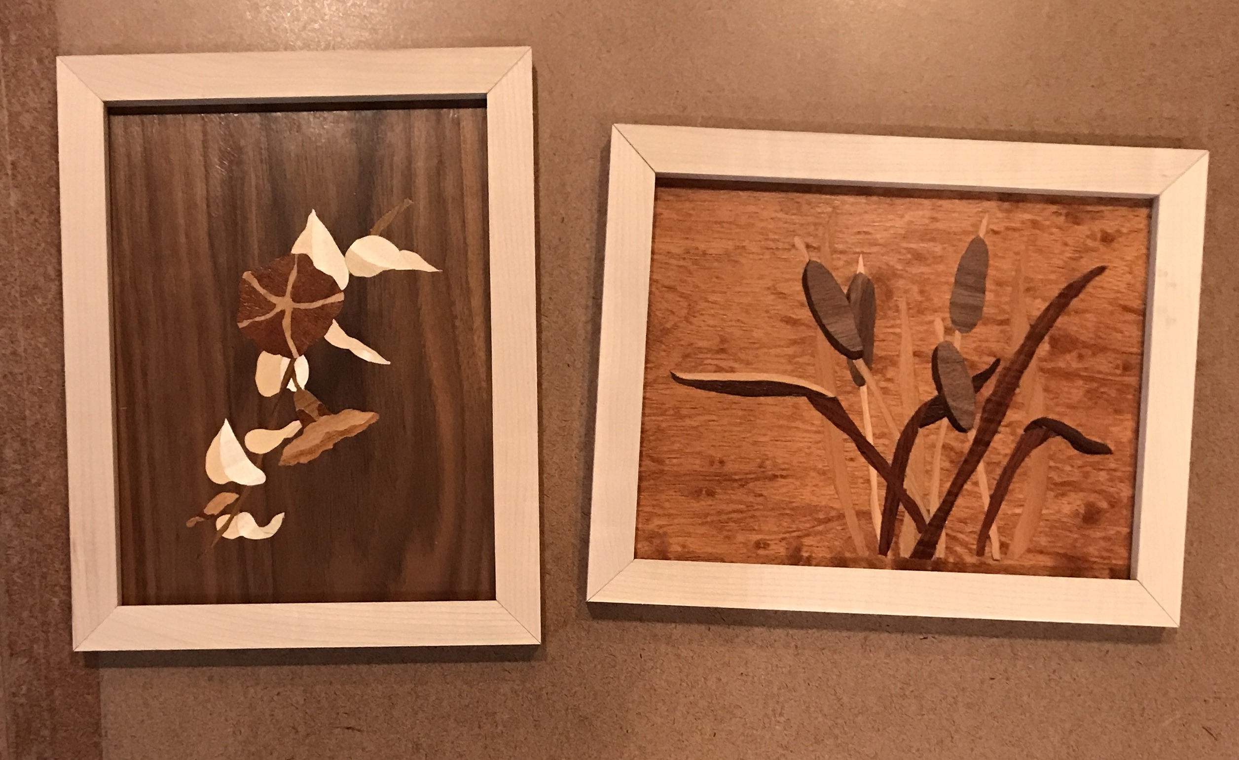 The frame members arranged around the marquetry pieces